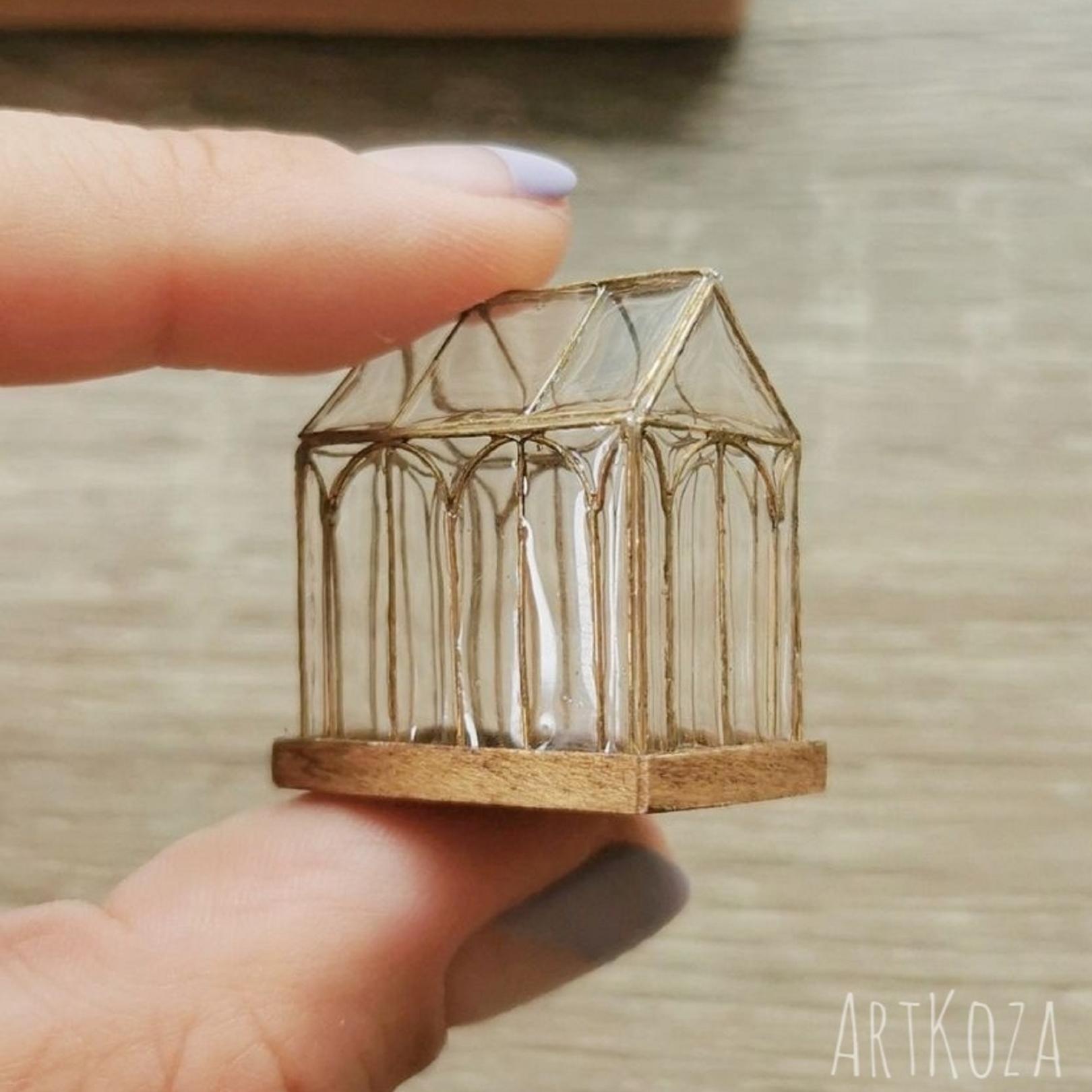 Modern miniature greenhouse on flat tray
