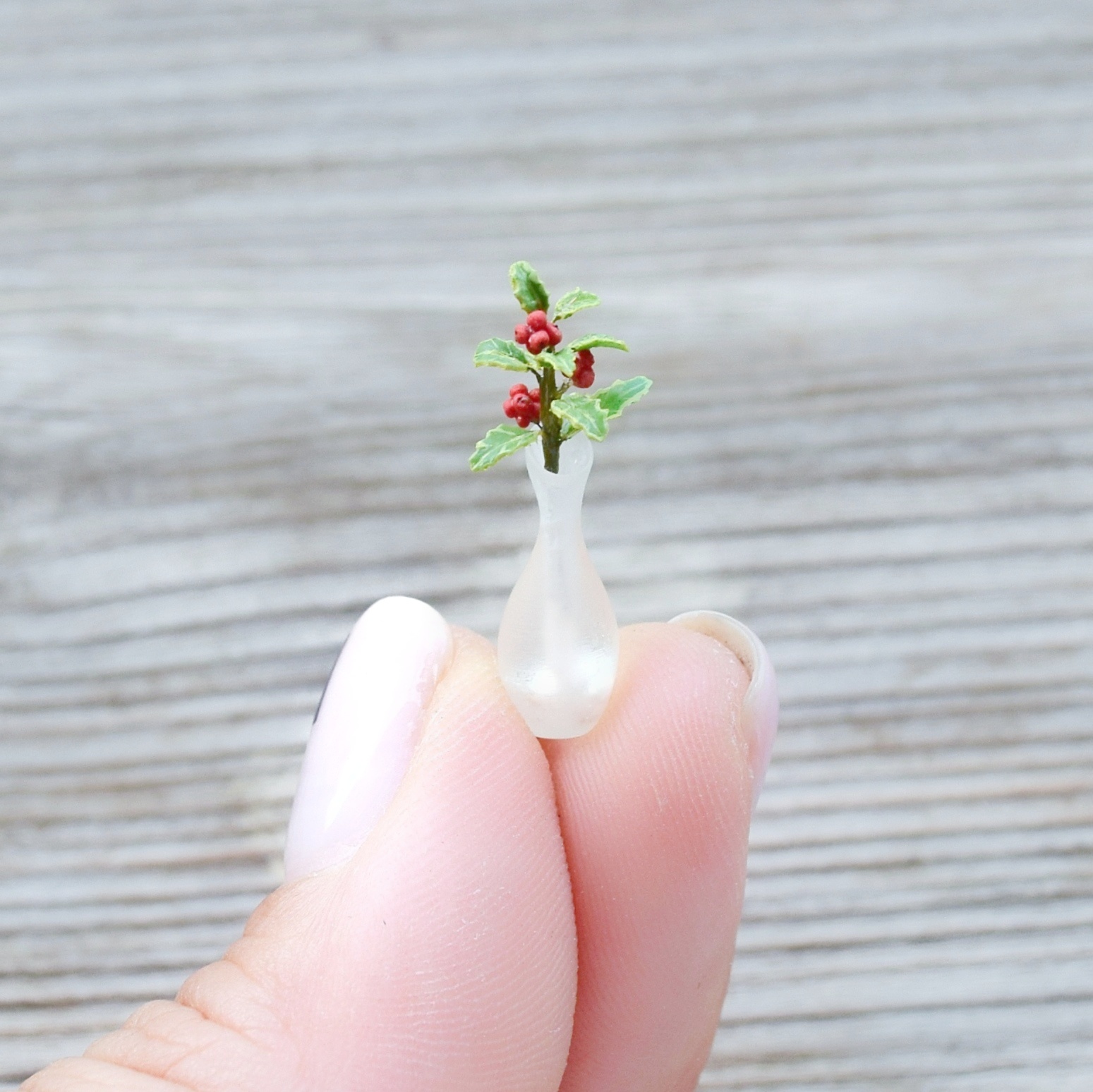 Holly plant decor. Vase with twig.